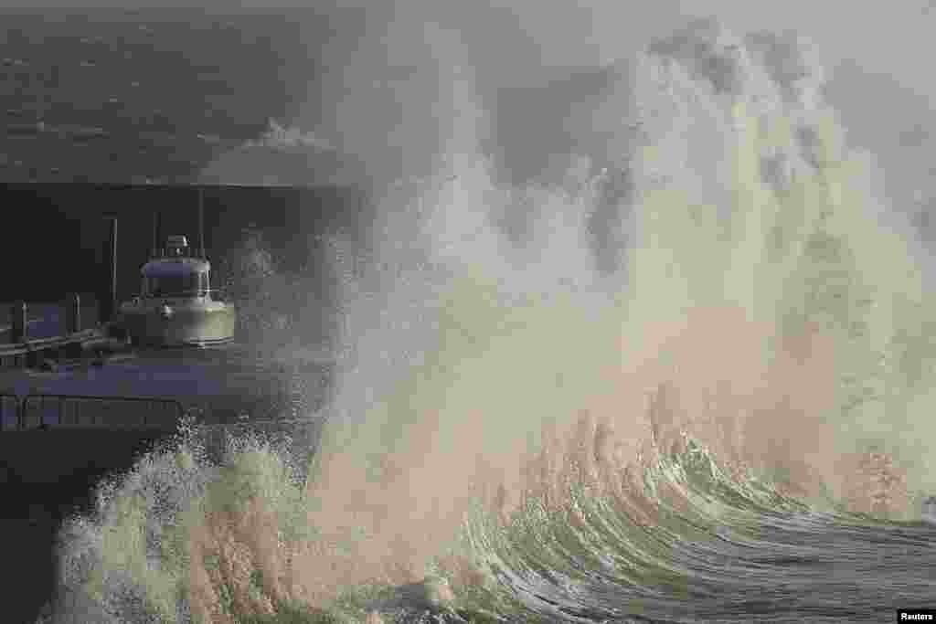 A high wave crashes on the protecting wall at the fishing harbour in Pornic, France as Carmen storm hits the French Atlantic coast, Jan. 01, 2018.