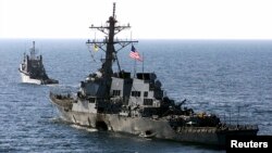 FILE - The U.S. Navy destroyer USS Cole is towed away from the port city of Aden, Yemen, into open sea by the Military Sealift Command ocean-going tug USNS Catawba, Oct. 29, 2000. 