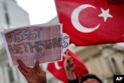 FILE - A group of Turks protest outside the Dutch consulate in Istanbul, March 12, 2017. Tensions began after the Netherlands and Germany blocked Turkish officials from holding rallies with ethnic Turks within the countries in support of an April referendum on broadening Erdogan's powers.