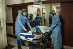 A nurse participates in a drill to test system capabilities for the potential mass influx of coronavirus patients at the Aga Khan University Hospital in Nairobi, Kenya, April 9, 2020.