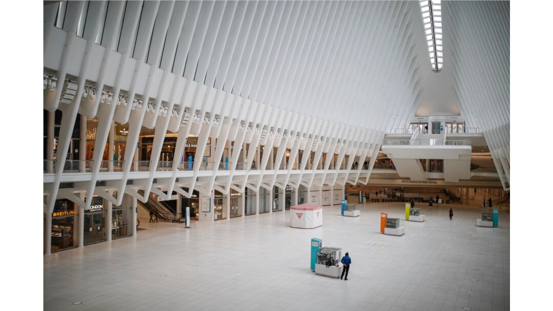 A pedestrian stands along in a sparsely populated transit hub in the downtown financial district as retail stores remain shuttered due to COVID-19 concerns, Saturday, March 21, 2020, in New York. New York Gov. Andrew Cuomo announced sweeping orders.