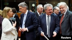 (L-R) European Union foreign policy chief Federica Mogherini, Britain's Foreign Secretary Philip Hammond, Luxembourg's Foreign Minister Jean Asselborn and Finland's Foreign Minister Erkki Tuomioja attend an European Union foreign ministers meeting in Brussels, March 16, 2015. 