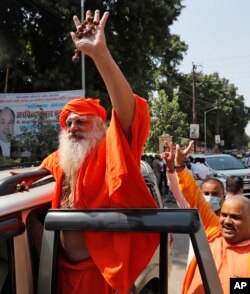 FILE - Hindu religious leader Dharam Das, an accused in the 1992 attack and demolition of a 16th century mosque, celebrates as he leaves a court in Lucknow, India, September 30, 2020. A court acquitted all 32 accused, including four from the nationalist Bharatiya Janata Party.