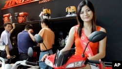 FILE - A model sits on a motor bike at a China-based Zongshen's booth during the Vietnam Auto Expo 2008 at Vietnam Exhibition & Fair Centre in Hanoi, Vietnam, June 11, 2008.