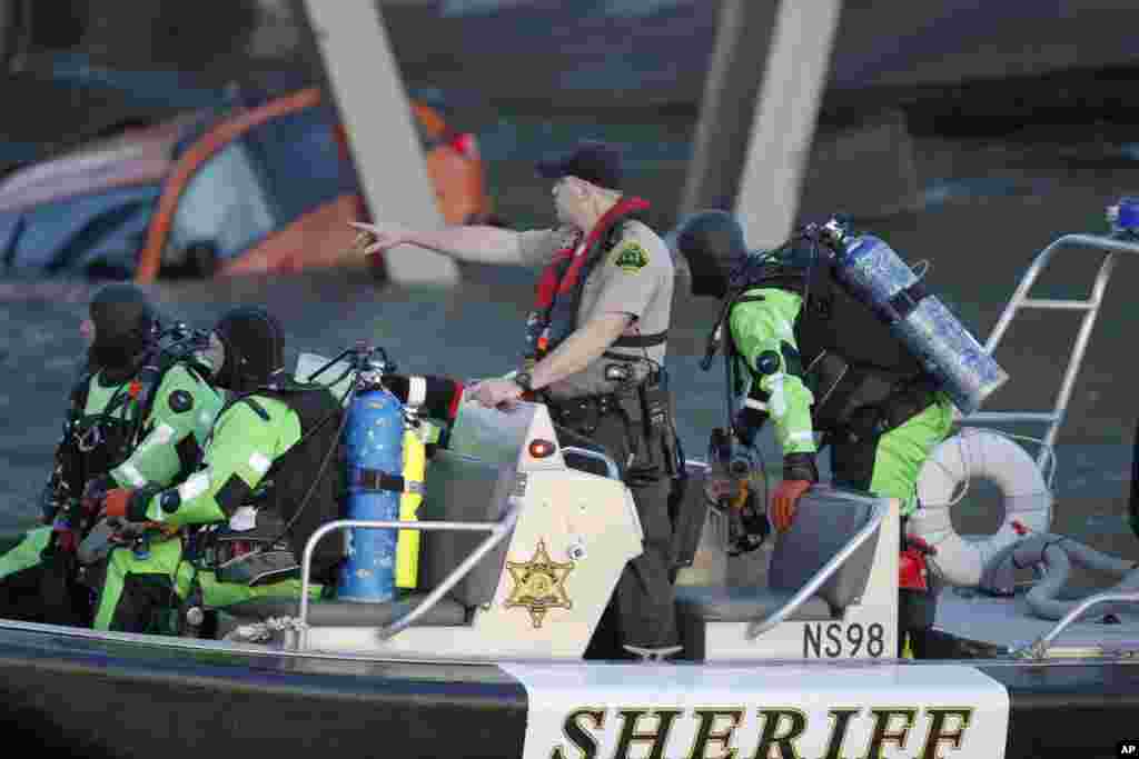 A rescue boat and divers search near the collapsed Interstate 5 bridge, Mount Vernon, Washington, May 23, 2013.