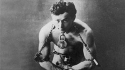 Legendary escape artist Harry Houdini is shown in chains in this photo circa 1899.