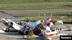 FILE - The wreckage of the Polish Tupolev Tu-154M presidential aircraft that killed Polish president Lech Kaczynski and 95 others is seen at the airport in Smolensk, Oct. 1, 2010.