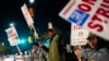 Boeing employees, including assembler Tyrone Hipolito, center, work the picket line after union members voted to reject a new contract offer from the company, Wednesday, Oct. 23, 2024, in Renton, Wash.