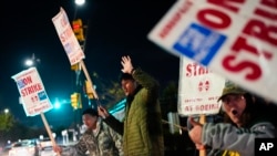 Boeing employees, including assembler Tyrone Hipolito, center, work the picket line after union members voted to reject a new contract offer from the company, Wednesday, Oct. 23, 2024, in Renton, Wash.