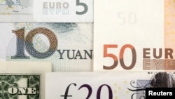 FILE - A picture illustration shows an arrangement of various world currencies including Chinese Yuan, US Dollar, Euro, British Pound.