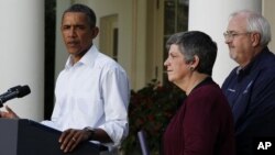 U.S. President Barack Obama speaks about damage done by Hurricane Irene next to Homeland Security Secretary Janet Napolitano (C) and Federal Emergency Management Agency Administrator Craig Fugate (R) in the Rose Garden of the White House, August 28, 2011