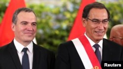 FILE - Peru's President Martin Vizcarra and new Prime Minister Salvador del Solar attend a swearing-in ceremony at the government palace in Lima, Peru, March 11, 2019.
