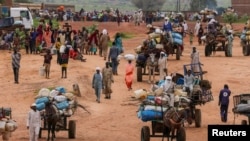 FILE - People fleeing the violence in West Darfur, cross the border into Adre, Chad, August 4, 2023.