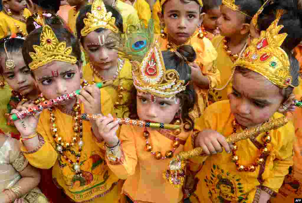 Schoolchildren dressed up as Hindu deity Krishna perform during celebrations on the eve of the Janmashtami festival that marks Krishna&#39;s birthday, in Amritsar. 