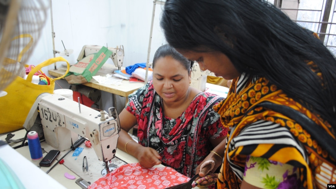 Women work in a tiny garment workshop opened and staffed by survivors of the collapse of Rana Plaza in Dhaka. (Amy Yee for VOA News)