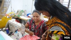 Women work in a tiny garment workshop opened and staffed by survivors of the collapse of Rana Plaza in Dhaka. (Amy Yee for VOA News)