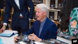 President Bill Clinton sign copies of "The President is Missing" at Book Revue on Thursday, June 28, 2018, in Huntington, New York. 