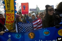 FILE - Demonstrators march during an immigration rally in support of the Deferred Action for Childhood Arrivals (DACA), and Temporary Protected Status (TPS), programs, on Capitol Hill in Washington, Dec. 6, 2017.