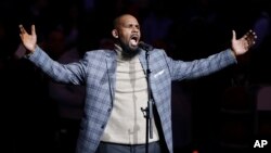 FILE - Musical artist R. Kelly performs the national anthem before an NBA basketball game between the Brooklyn Nets and the Atlanta Hawks in New York.