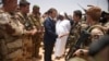 French President Emmanuel Macron, center, and Mali's President Ibrahim Boubacar Keita, center right, visit soldiers of Operation Barkhane, France's largest overseas military operation, in Gao, Northern Mali, May 19, 2017. 