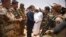 French President Emmanuel Macron, center, and Mali's President Ibrahim Boubacar Keita, center right, visit soldiers of Operation Barkhane, France's largest overseas military operation, in Gao, Northern Mali, May 19, 2017. 
