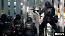 Riot policemen fire rubber bullets during clashes with anti-government protesters at the Thai-Japan youth stadium in central Bangkok, Dec. 26, 2013.