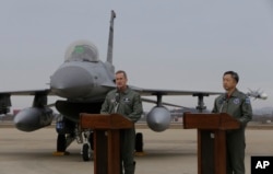 FILE - Lt. Gen. Terrence O'Shaughnessy, left, 7th Air Force commander of the U.S. Forces to Korea, speaks in front of a U.S. F-16 fighter jet as South Korean Air Forces Commander Lee Wang-geun listens at the Osan Air Base in Pyeongtaek, South Korea, Jan. 10, 201