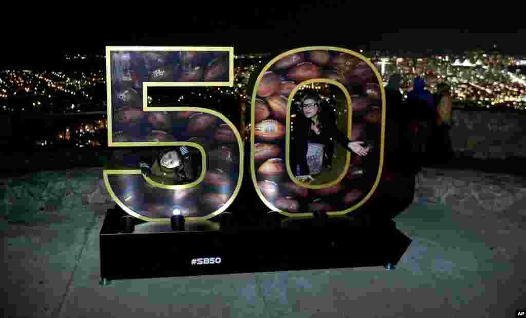 Erika Moya (l), and Ashley King, pose for a photo in a Super Bowl 50 display at a park overlooking San Francisco. The Denver Broncos play the Carolina Panthers in the NFL Super Bowl 50 football game Sunday, Feb. 7, 2015 in Santa Clara,&nbsp;Calif.