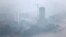 The city skyline is shrouded by a layer of mist after a torrential rain in Pyongyang, July 22, 2013.