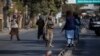 FILE - Taliban fighters block a road after an incident in Kabul, Afghanistan, Nov. 2, 2021.