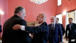 Secretary of State Mike Pompeo (L) is greeted by Afghan President Ashraf Ghani, at the Presidential Palace in Kabul, Afghanistan, June 25, 2019, during an unannounced visit.