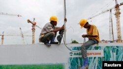 FILE - Workers work at the Vietnam Hoang Anh Gia Lai (HAGL) construction site in Rangoon, Sept. 20, 2013.