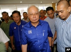 FILE - Defeated Malaysian Prime Minister Najib Razak prepares for a press conference in Kuala Lumpur, Malaysia, May 10, 2018.