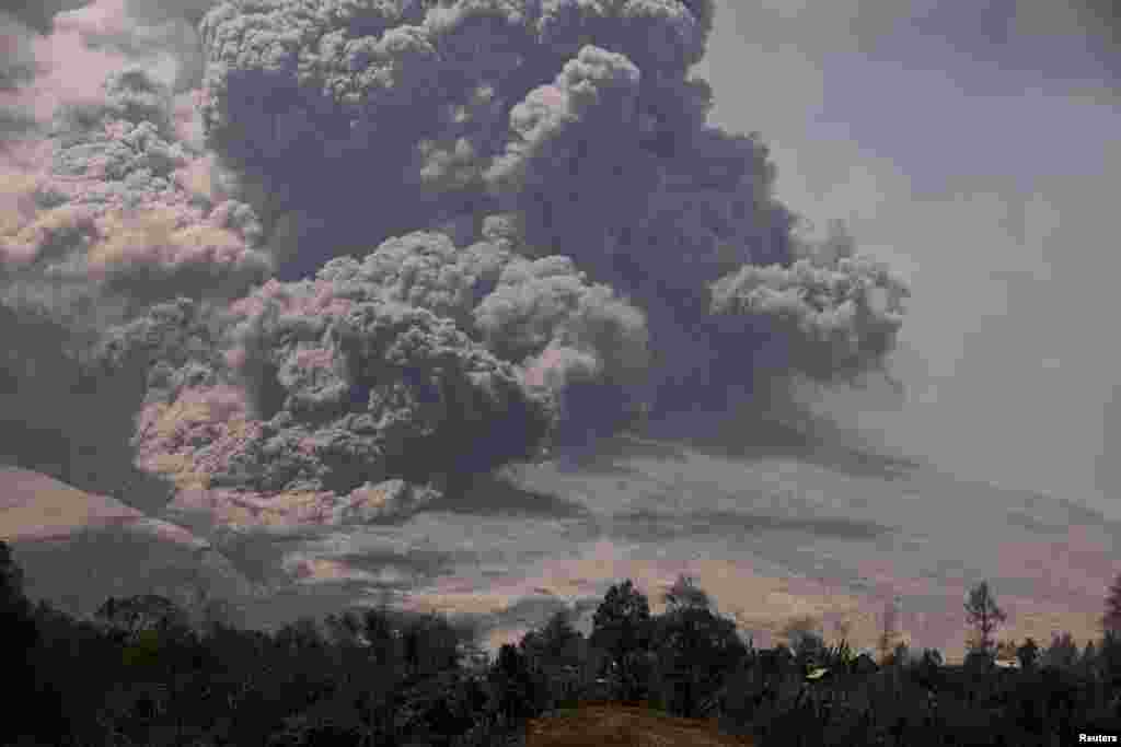 Mount Sinabung spews ash as seen from Payung village in Karo district, North Sumatra province, Indonesia, Feb. 3, 2014.