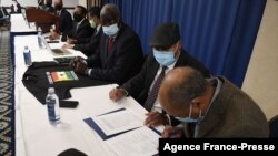 Representatives of nine factions opposed to Ethiopian Prime Minister Abiy Ahmed participate in a signing ceremony to form a new alliance called the "United Front of Ethiopian Federalist and Confederalist Forces" at the National Press Club in Washington, Nov. 5, 2021.