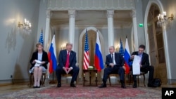 Russian President Vladimir Putin and U.S. President Donald Trump, with their interpreters at the beginning of their meeting at the Presidential Palace in Helsinki, Finland, July 16, 2018.