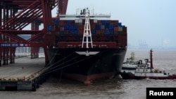 A cargo ship is anchored at a port in Zhoushan, Zhejiang province, Feb. 14, 2016. China's exports fell 11.2 percent in January from a year earlier and imports tumbled 18.8 percent.