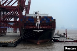 FILE - bA cargo ship is anchored at a port in Zhoushan, Zhejiang province, Feb. 14, 2016. China's exports fell 11.2 percent in January from a year earlier and imports tumbled 18.8 percent.