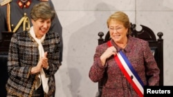 Chile's President Michelle Bachelet smiles next to Senate President Isabel Allende (L), daughter of late former President Salvador Allende, after delivering her annual address at the national congress building in Valparaiso city, northwest of Santiago, Ma