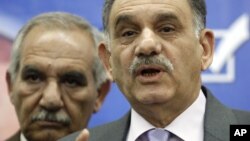 In this February. 25, 2010 file photo, Iraq’s Deputy Prime Minister Saleh al-Mutlaq, right, speaks to reporters in Baghdad, Iraq. 
