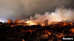 The remains of a fertilizer plant burn after an explosion at the plant in the town of West, near Waco, Texas, early April 18, 2013. 