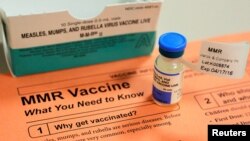 FILE - A vial of measles, mumps and rubella vaccine and an information sheet is seen at Boston Children's Hospital in Boston, Massachusetts, Feb. 26, 2015. 