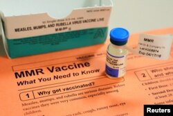 FILE - A vial of measles, mumps and rubella vaccine and an information sheet is seen at Boston Children's Hospital in Boston, Massachusetts, Feb. 26, 2015.