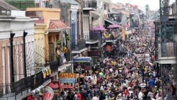FILE - In this Tuesday, Feb. 25, 2020, file photo, Bourbon Street is a sea of humanity on Mardi Gras day in New Orleans.