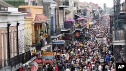 FILE - In this Tuesday, Feb. 25, 2020, file photo, Bourbon Street is a sea of humanity on Mardi Gras day in New Orleans.