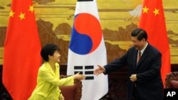 FILE - South Korean President Park Geun-hye, left, and Chinese President Xi Jinping, Great Hall of the People, Beijing, June 27, 2013.