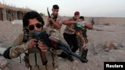 FILE - Shi'ite volunteers, who have joined the Iraqi army to fight against Islamic State militants, take part in a military-style training in Basra, Iraq. 