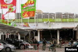 Military personnel inspect the site of a bomb attack at a supermarket in Pattani, Thailand, May 10, 2017.