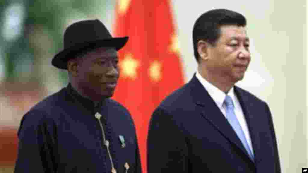 Chinese President Xi Jinping stands with Nigerian President Jonathan during a welcome ceremony at the Great Hall of the People in Beijing..
