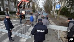 City workers put up barriers around the Israeli Embassy in Warsaw, Poland, Jan. 31, 2018, after a local governor, citing security concerns, banned traffic in the area in order to prevent a planned protest by far-right groups.
